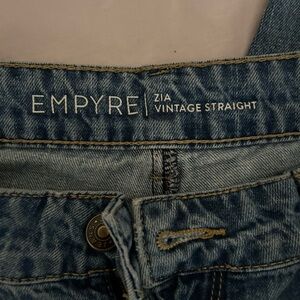 Jeans worn heavily, bottoms are a little ragged